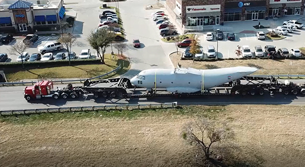2 Lone Star truck hauling airplane part on highway