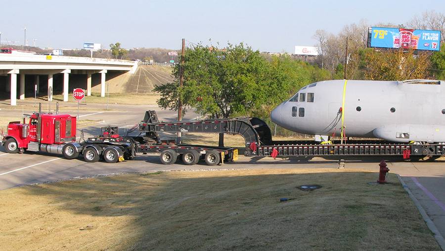 Lone Star Transportation truck hauling airplane on highway