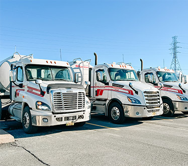 Closeup of parked Seaboard Transport Group cabs and tanker trailers