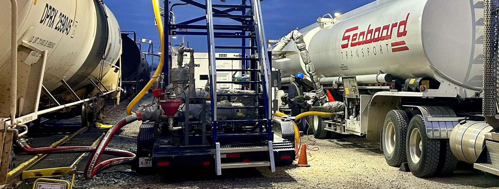 Bulk liquid freight being transloaded from Seaboard double tanker truck to rail