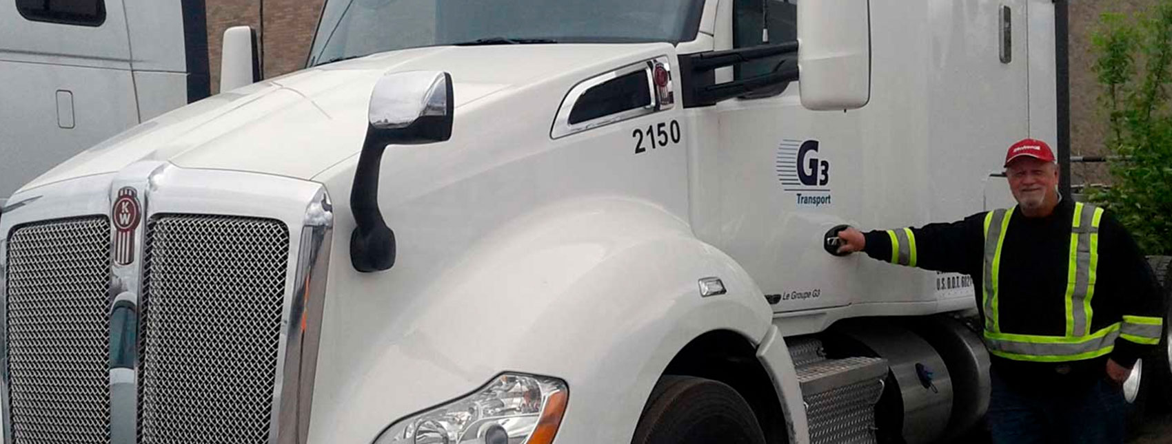 G3 Transport driver standing beside tractor cab