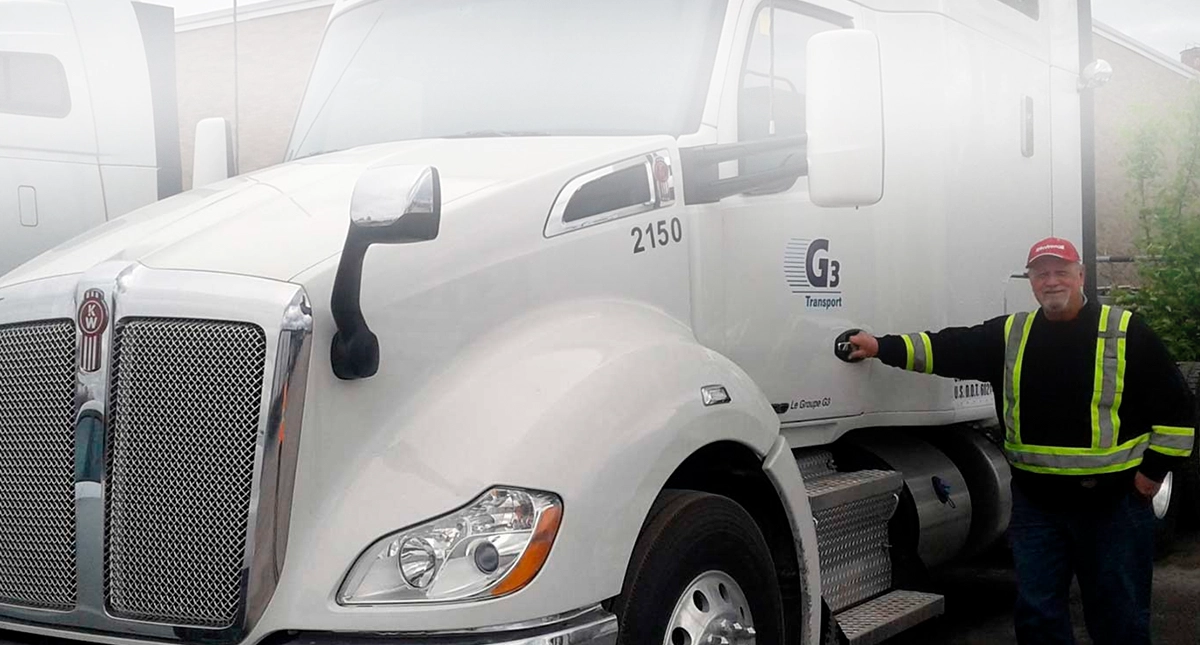 G3 Transport driver standing beside tractor cab